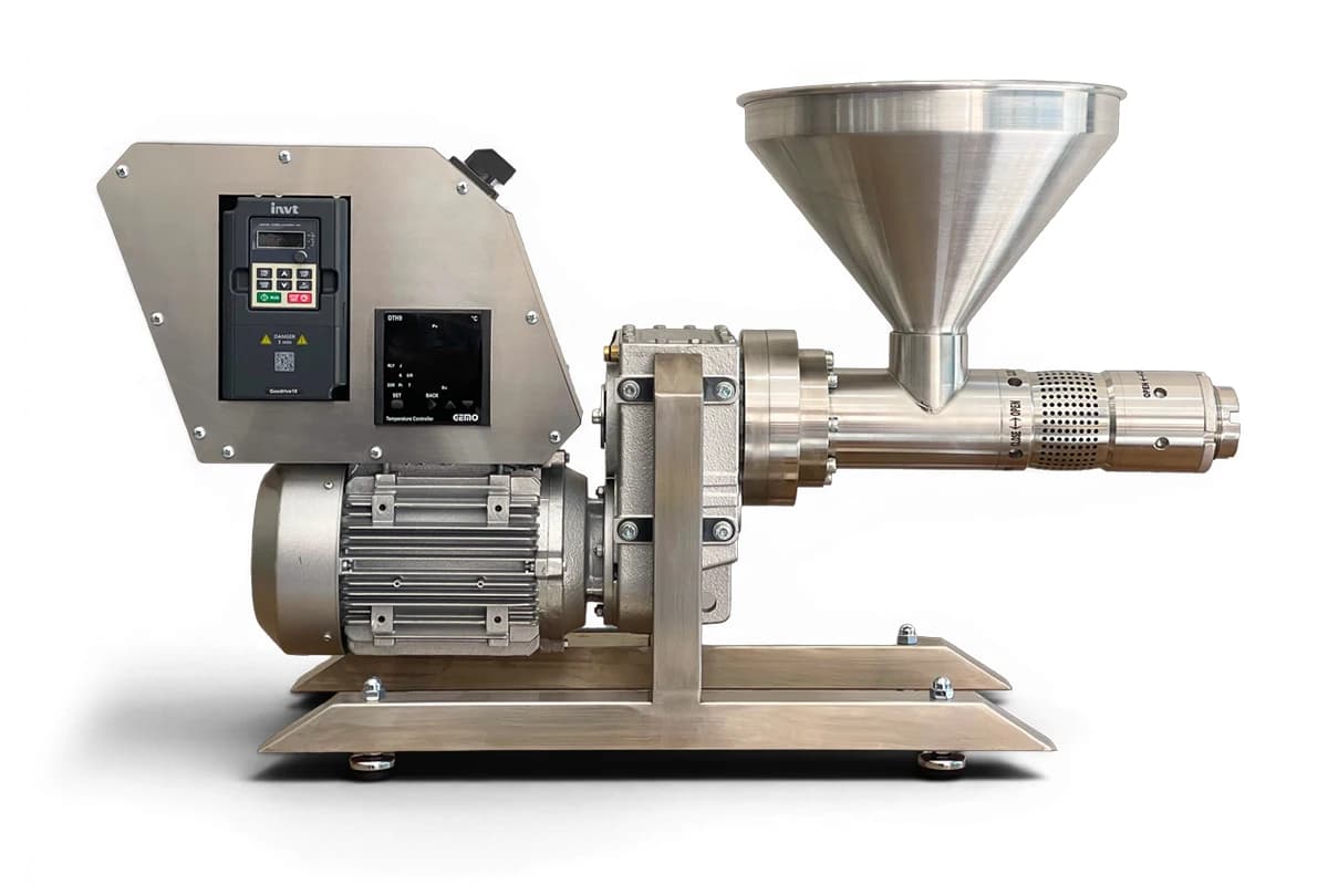 CBP1500 cocoa nib screw press with a feed hopper, screw barrel, motor and temperature controls. Reference equipment photograph.