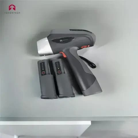 Torontech handheld XRF alloy analyzer with a pistol-style body and battery. Reference equipment photograph.
