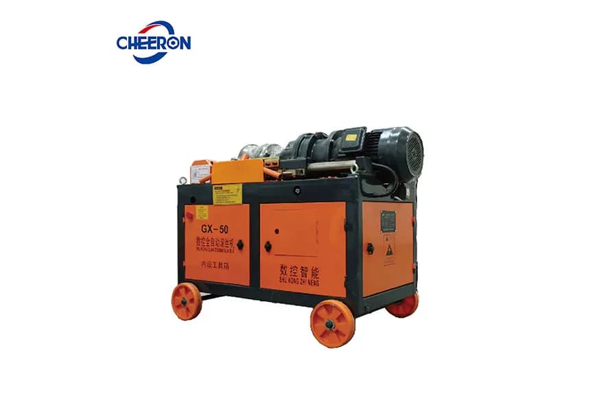 Orange rebar thread-rolling machine with a clamping head, motor and mobile base. Reference equipment photograph.