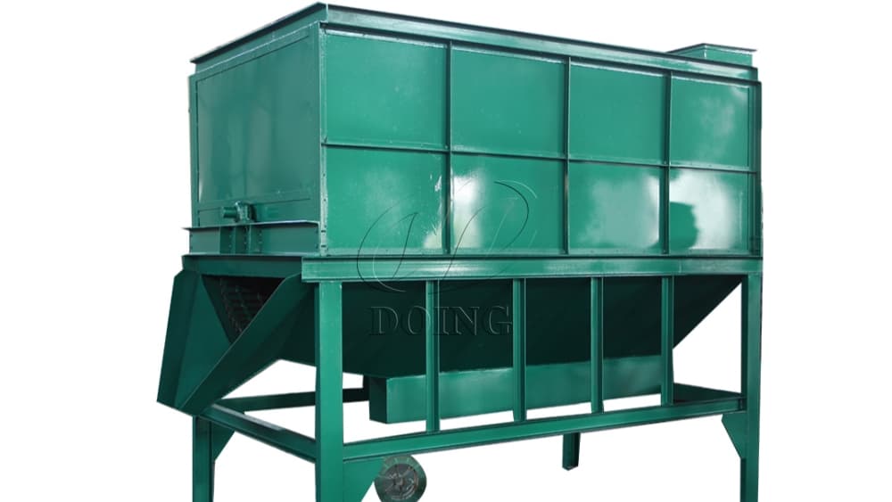 Glory Oiltech palm fruit thresher with an enclosed green threshing body, support frame and lower outlet. Reference equipment photograph.