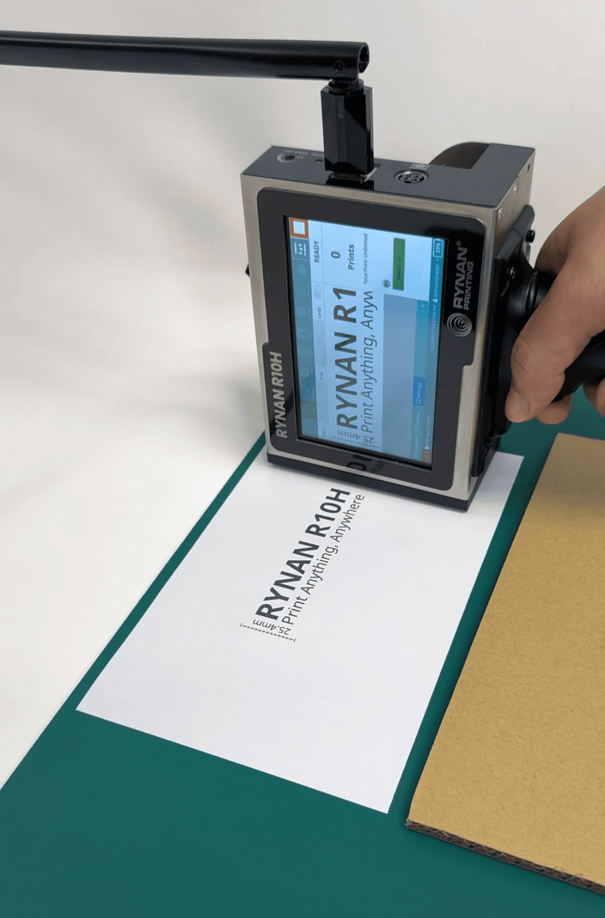 RYNAN R10H handheld printer marking a sample surface