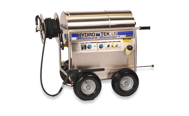 Hydro Tek wheeled hot-water pressure washer with heated coil enclosure and hose reel. Reference equipment photograph.
