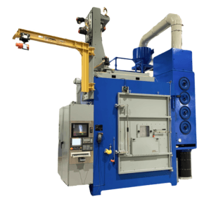 IPS rotary-table peening cell with chamber, control cabinet and nozzle motion support. Reference equipment photograph.