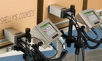 Videojet 2120 large-character printers coding cartons on a production conveyor. Reference equipment photograph.