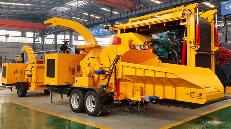 Kowloon towable wood chipper photographed on its wheeled trailer frame inside a workshop. Reference equipment photograph.