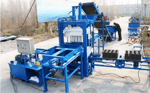 Mechpro paver block forming equipment with feeder and controls outdoors. Reference equipment photograph.