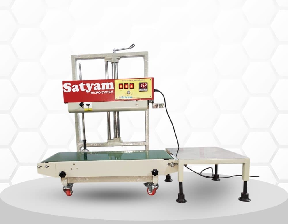 Satyam continuous band sealer with a raised sealing head and supporting conveyor. Reference equipment photograph.