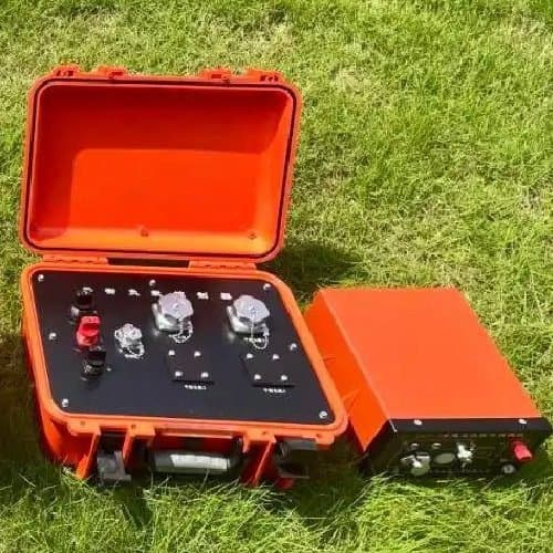 Orange field IP instrument case and power equipment photographed on grass. Reference equipment photograph.
