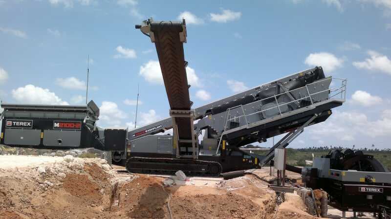 Tracked Terex mobile wash screen with raised conveyors photographed at an aggregate site. Reference equipment photograph.
