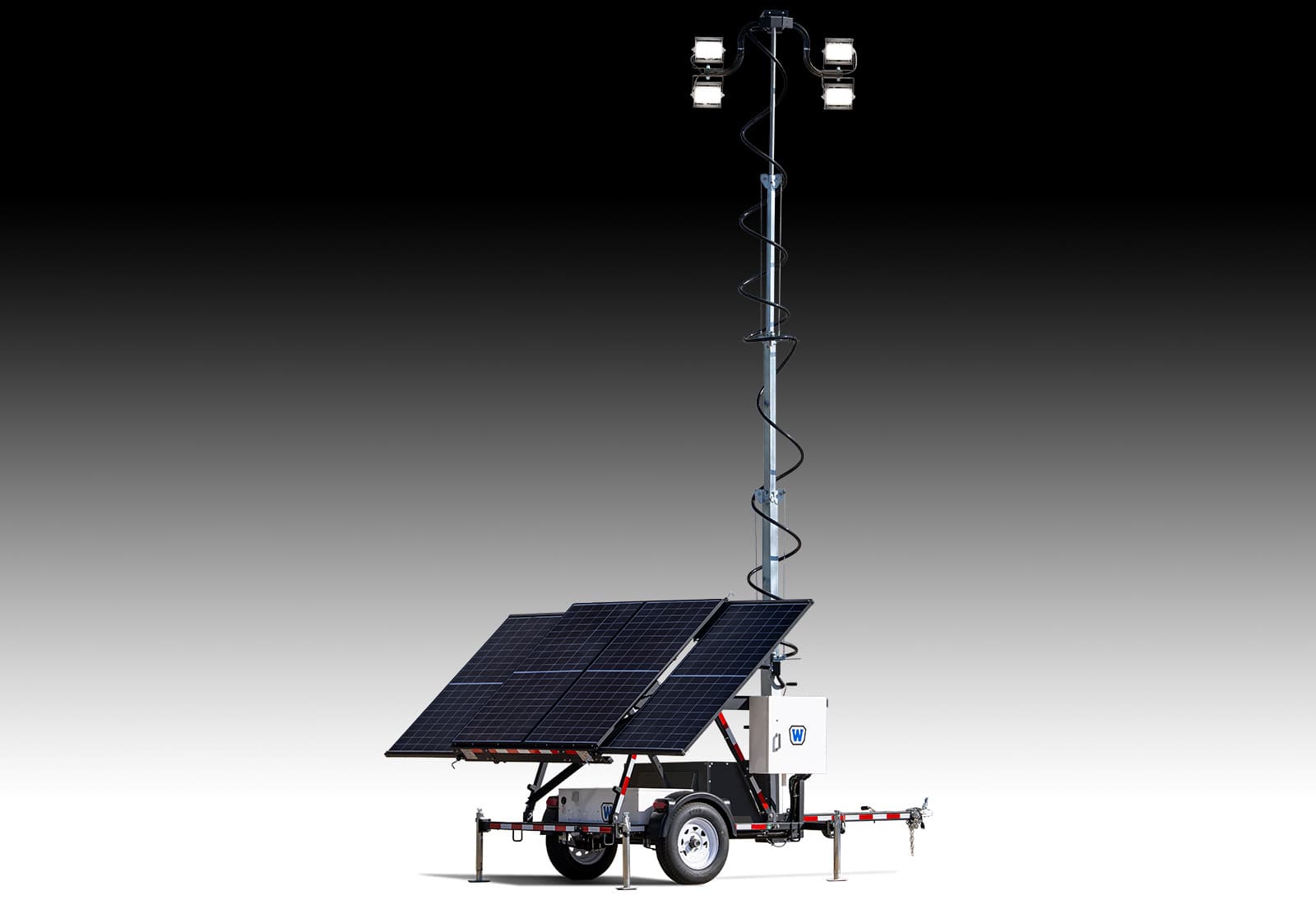Trailer-mounted light tower with extended mast, four floodlights, solar-panel array, stabilizers and equipment cabinets. Reference equipment photograph.