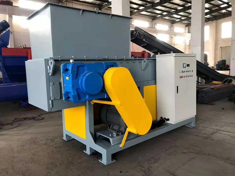 Kailong single-shaft plastic shredder photographed in a workshop with its feed hopper and guarded drive. Reference equipment photograph.