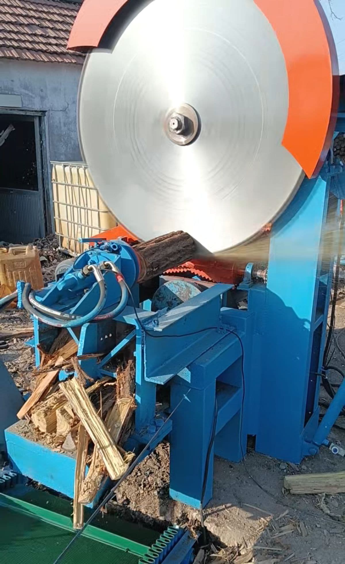 Lonwood firewood processor showing its circular crosscut saw and hydraulic splitting section in a workshop. Reference equipment photograph.
