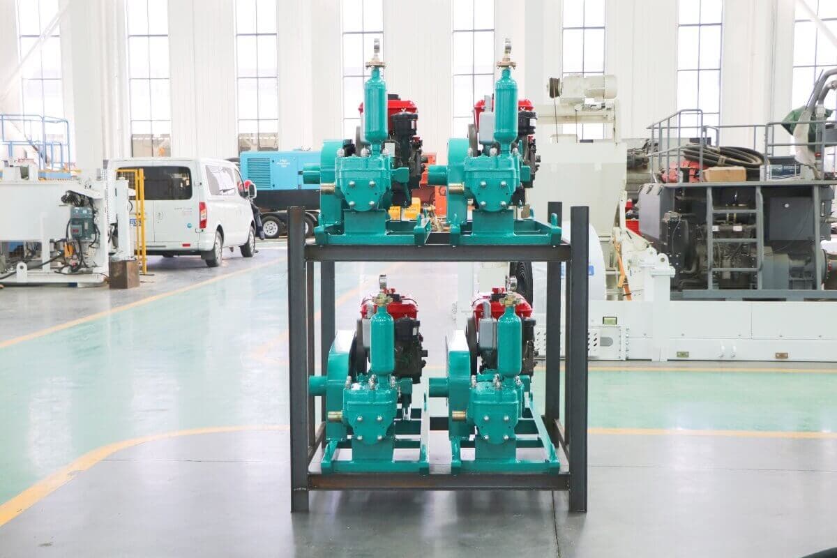 Cement grouting pumps photographed on display racks in a factory. Reference equipment photograph.