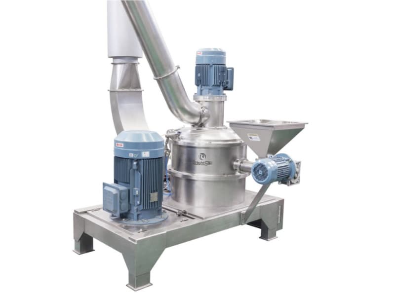 Brightsail air classifier mill with a cylindrical grinding chamber, top-mounted classification drive and feed hopper. Reference equipment photograph.