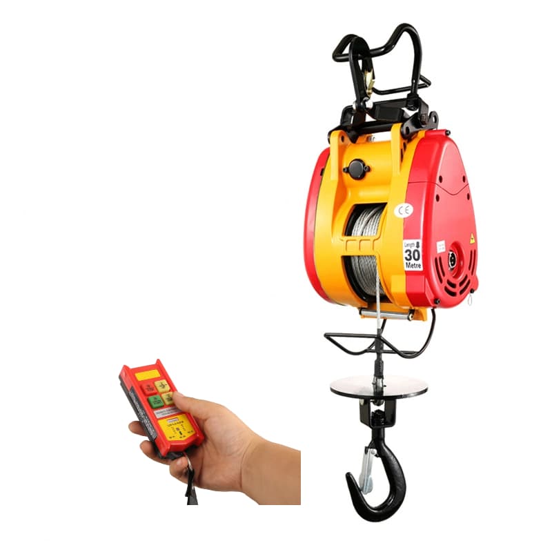 Red and yellow compact hanging electric hoist with upper support hooks, visible steel rope, lower load hook and wired control pendant. Reference equipment photograph.