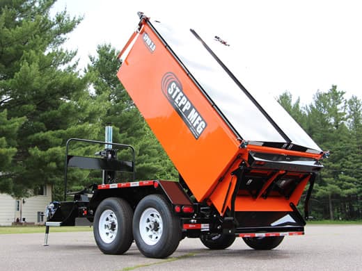 Stepp trailer-mounted asphalt hot box with a tipping heated material chamber. Reference equipment photograph.