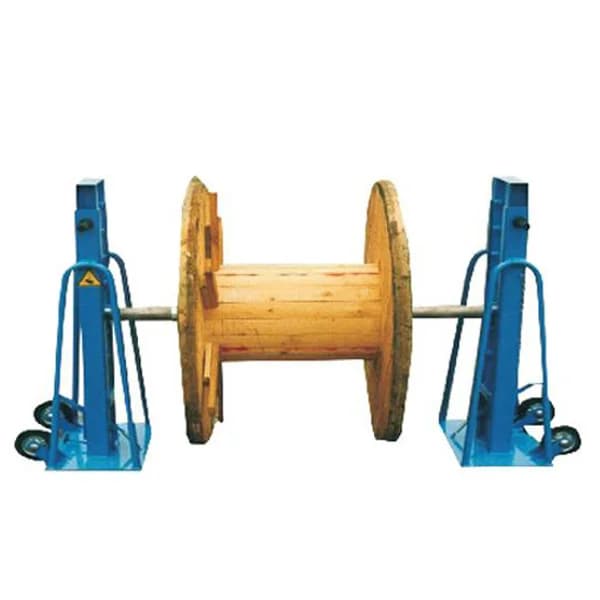 Two blue hydraulic drum supports holding a cable drum on an axle. Reference equipment photograph.