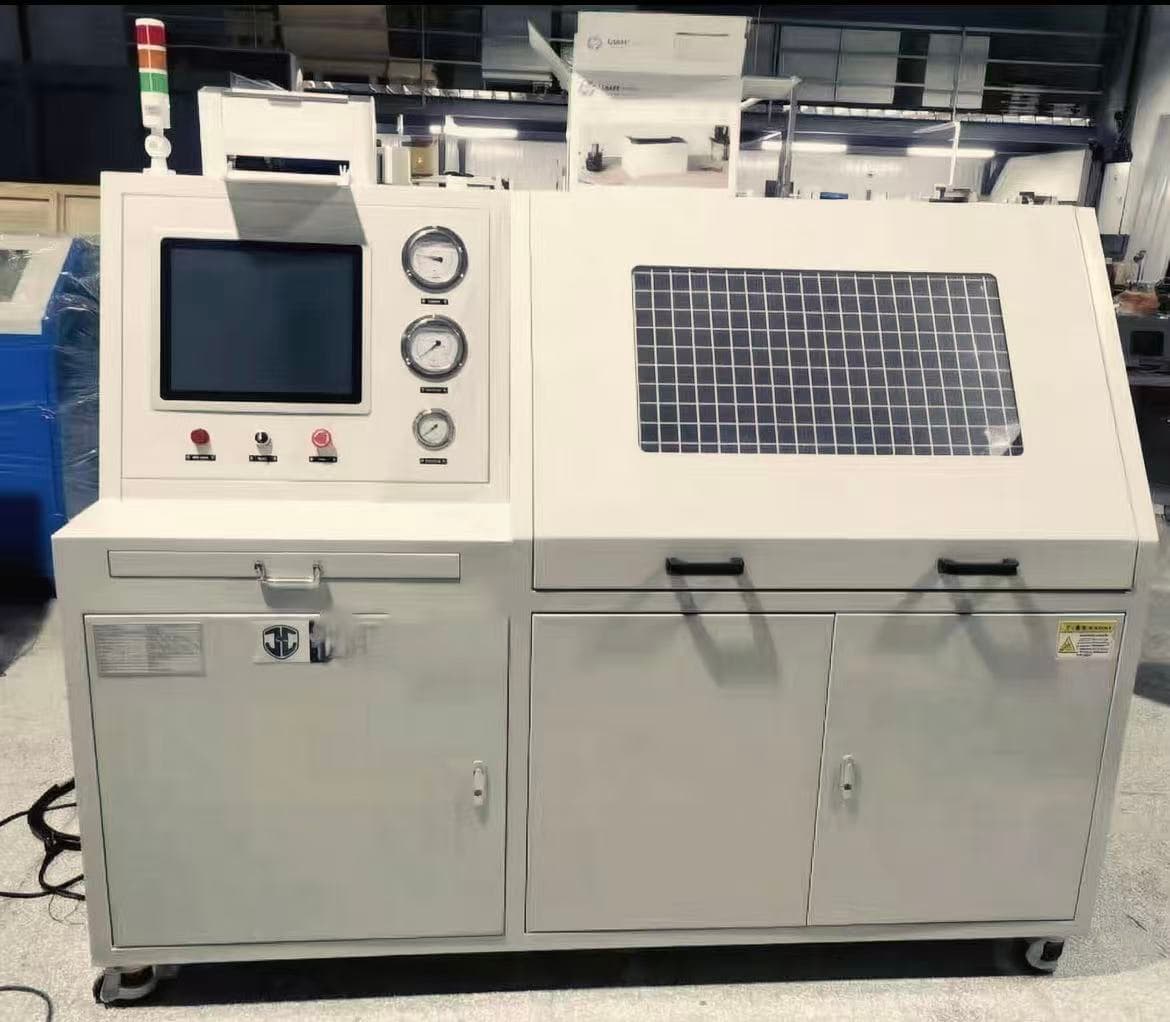 Enclosed hose test cabinet with gauges, control screen and pressure-bearing test chamber. Reference equipment photograph.