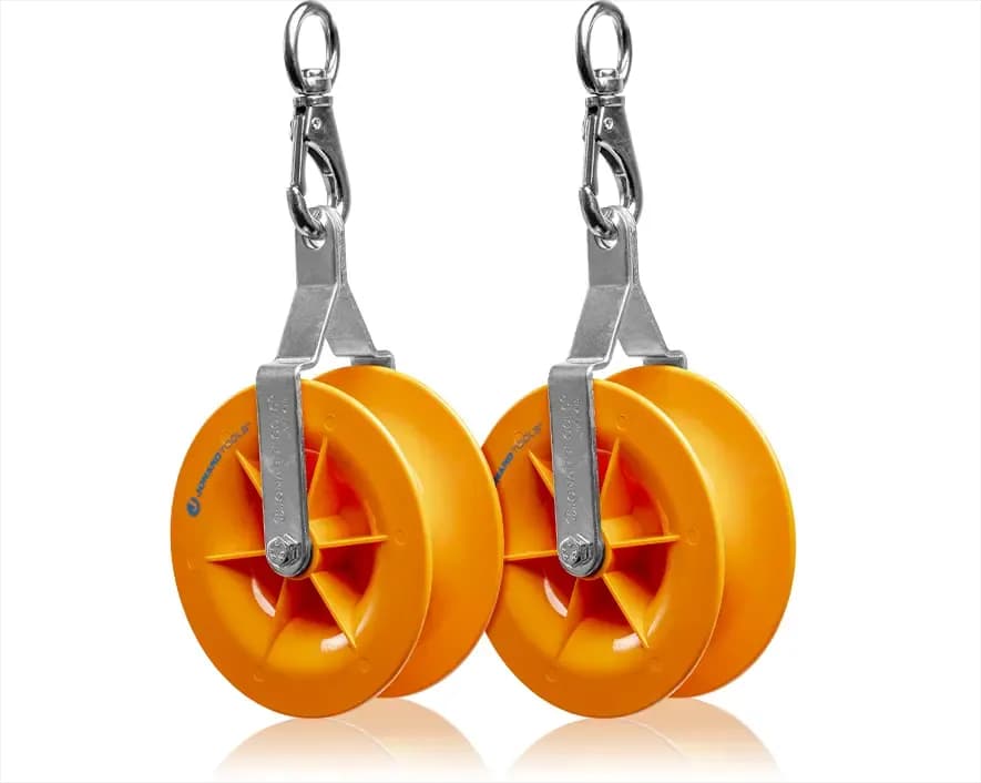 Two yellow cable pulleys with metal swivel suspension hooks. Reference equipment photograph.