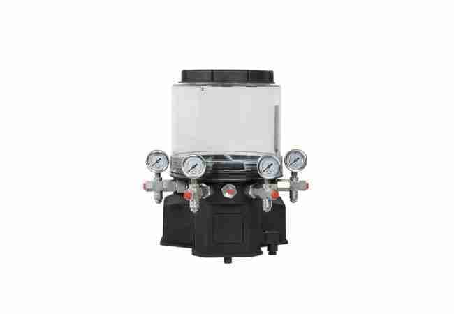 Electric multi-outlet grease lubrication pump with translucent reservoir, motor housing, pressure gauges and grease outlet assemblies. Reference equipment photograph.