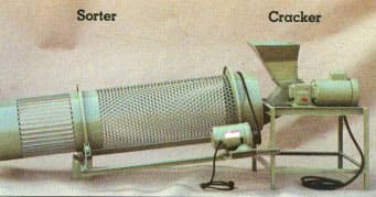 Historical Shaw macadamia cracker at the right of the photograph, beside a separate mesh-drum sorter. Reference equipment photograph.