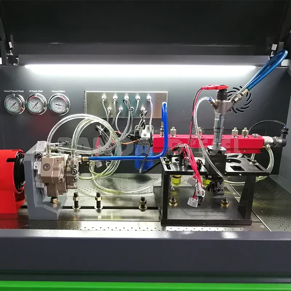 Manufacturer detail photograph of pump fixtures, pressure gauges and hoses inside a diesel test chamber