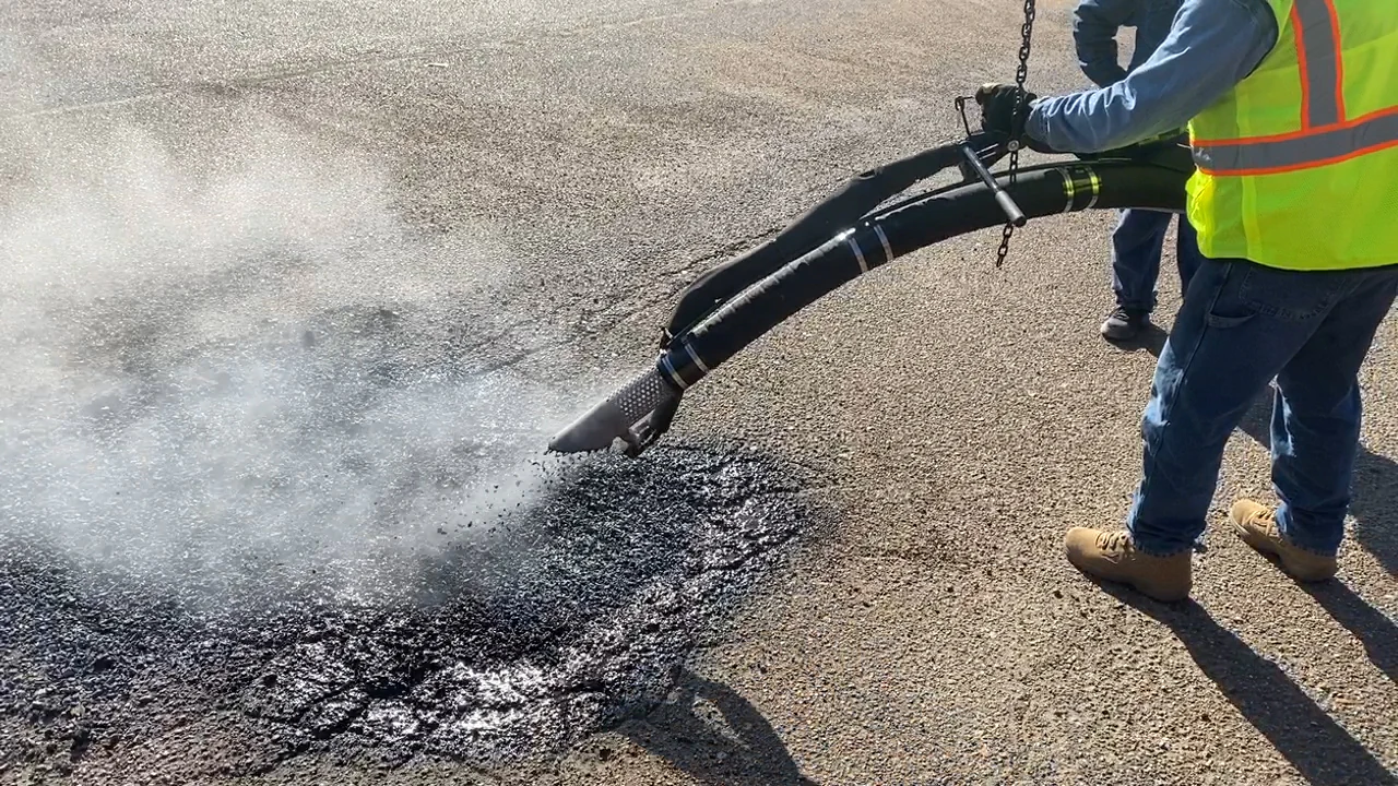 Cimline manufacturer application view of aggregate being placed in a pavement repair